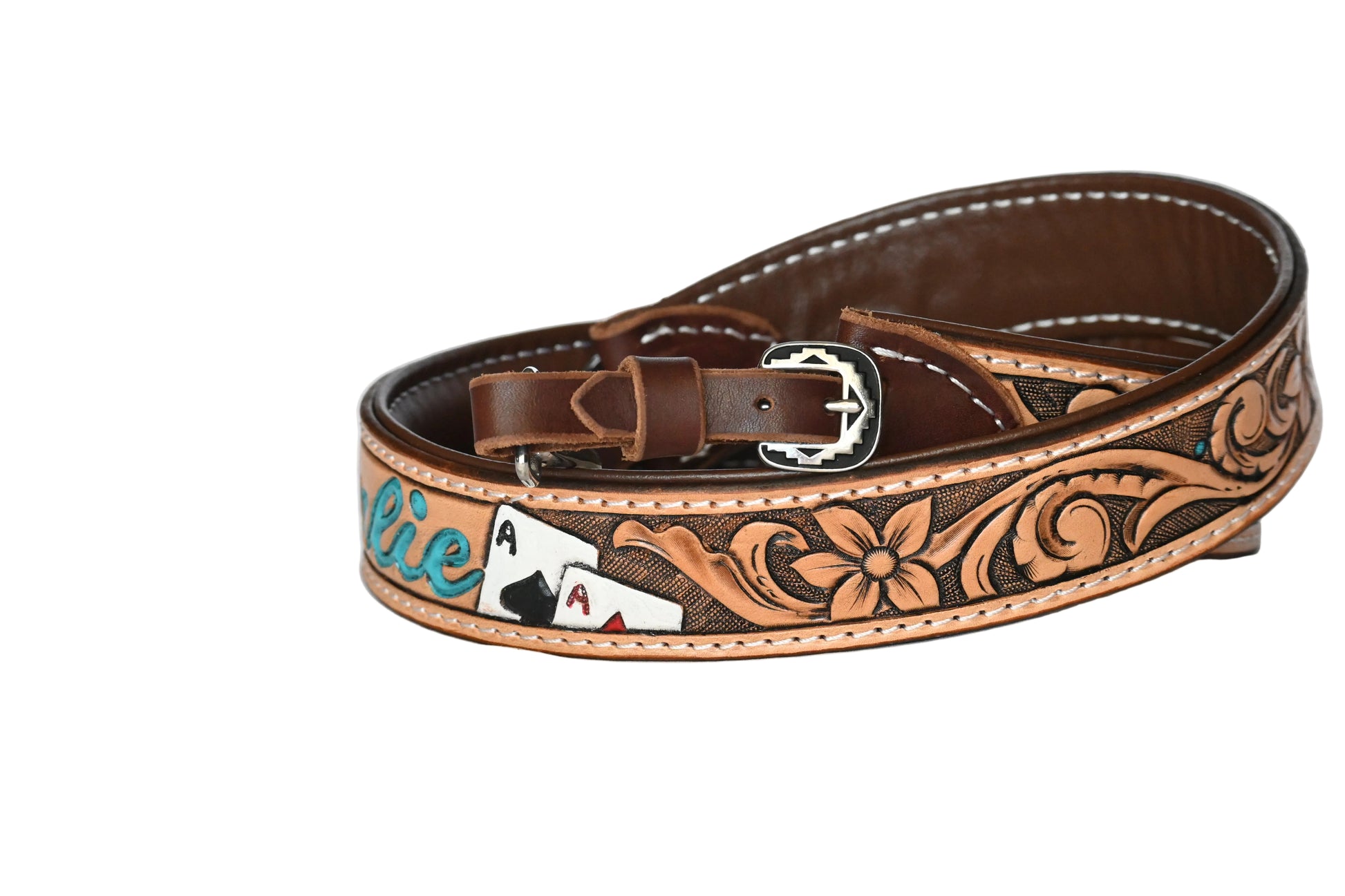Brown leather belt with floral patterns and a silver buckle on a white background